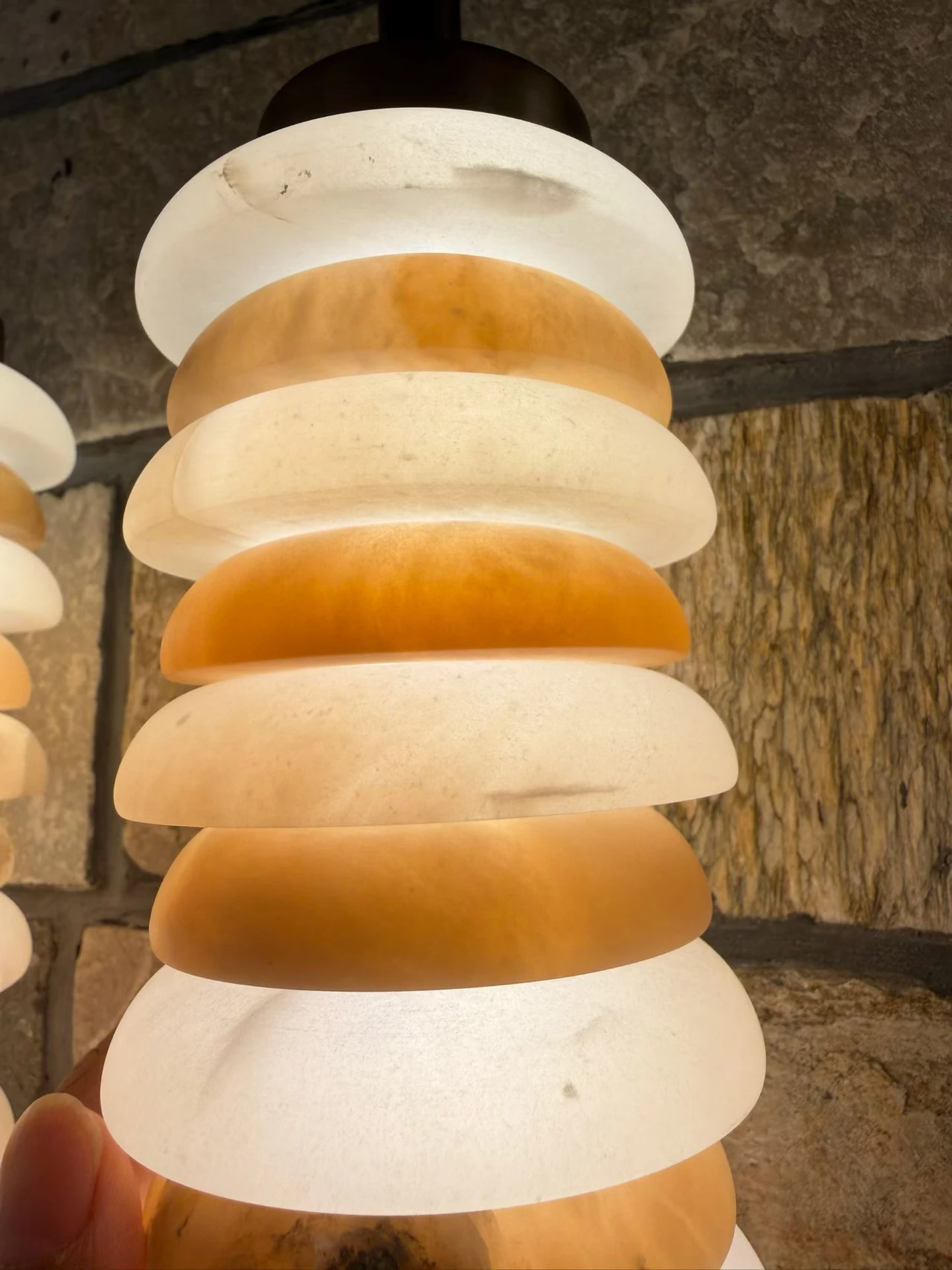 Alabaster pendant with stacked white and amber disc-shaped shades