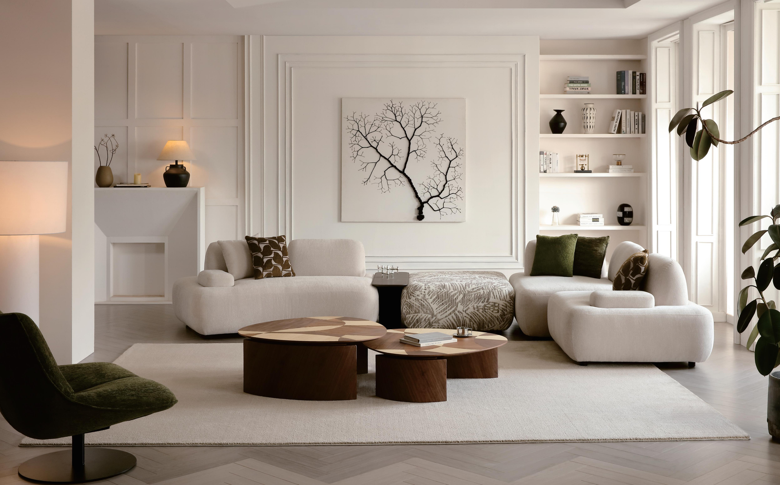 White curved sofa modules, patterned ottoman and wooden coffee tables in a living room